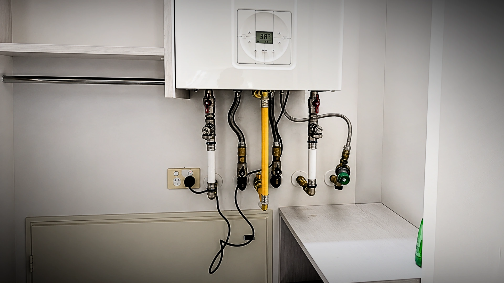 Commercial plumber servicing plant room pipework in a Napier business premises