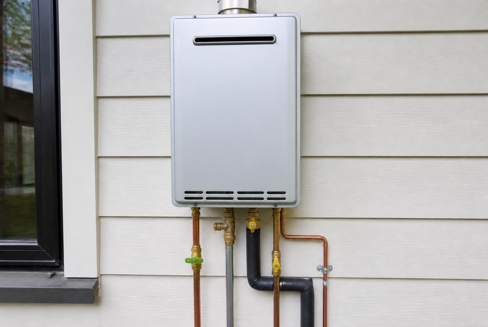 Certified gasfitter servicing a wall-mounted gas hot water unit in Napier